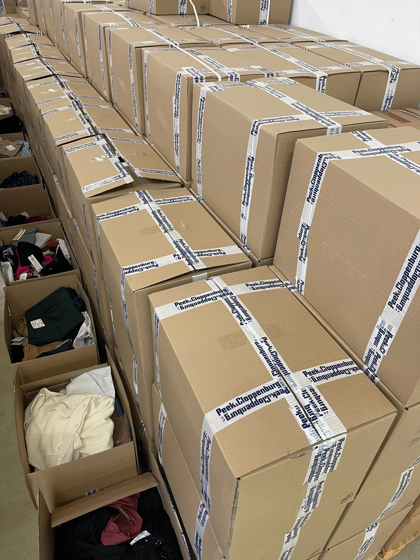 Rows of cartons and open boxes filling the warehouse hall